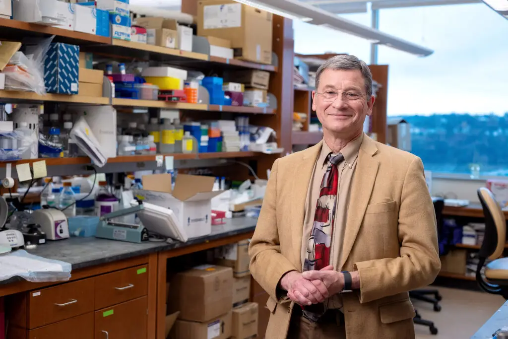 Dr. Vockley standing at his lab bench
