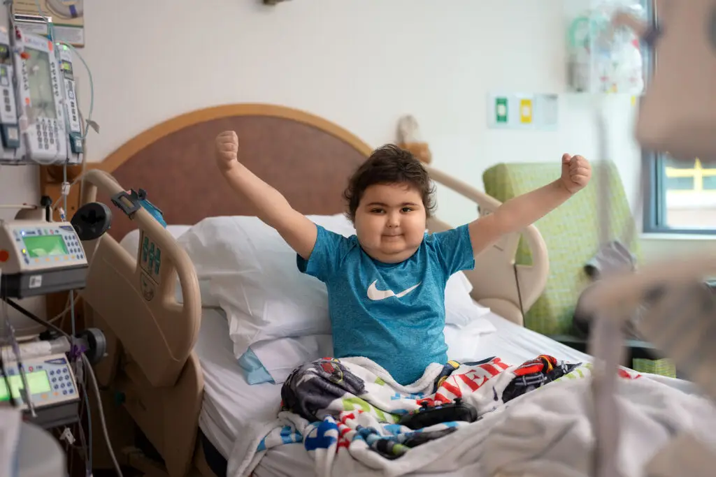 River, a pediatric patient at UPMC Children’s Hospital of Pittsburgh, smiles in a brightly lit hospital room where he receives compassionate care