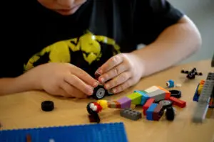 a child building a Lego car