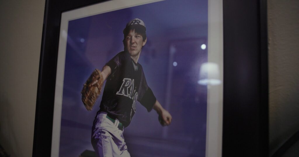 a photo of a framed picture of a boy pitching a baseball