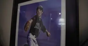 a photo of a framed picture of a boy pitching a baseball