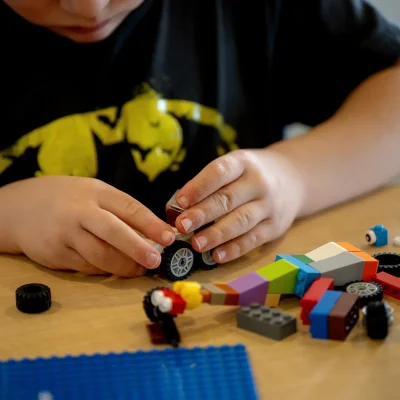 a child building a Lego car